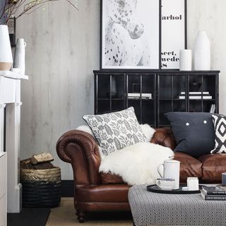 living area with brown sofa and cushions and black cabinet
