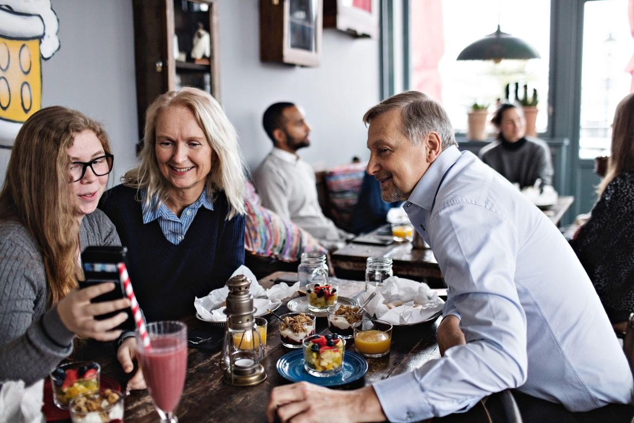 Family sitting indoors together at a restaurant