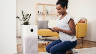 African American woman setting up air purifier