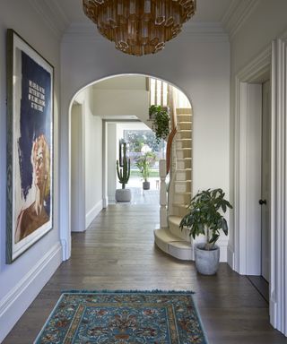 hallway with rug and large print and wooden floors