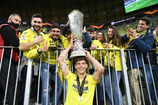 Villarreal’s Pau Torres celebrates with the trophy and fans after the UEFA Europa League final