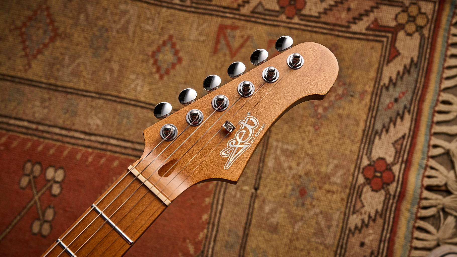 The headstock of a Jet JJ-300 P90 electric guitar