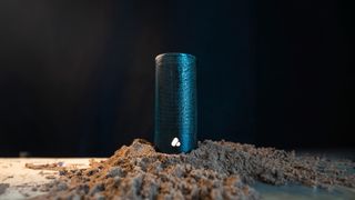 Poca Pine Beat Bluetooth speaker on a small mound of sand