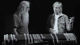 A still from McCartney 3, 2, 1 in which Paul McCartney and Rick Rubin are stood side-by-side talking.