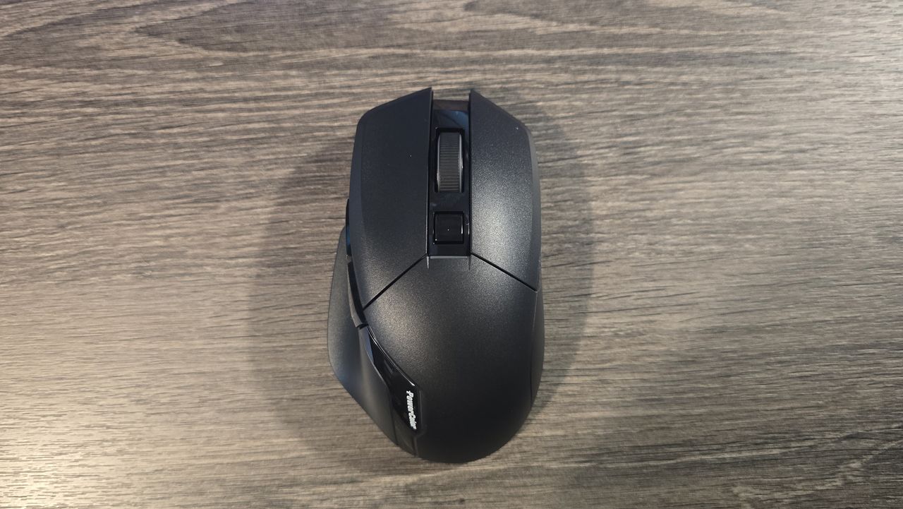 Powercolor Alphyn AM10 Wireless Gaming Mouse with RGB enabled on a desk.