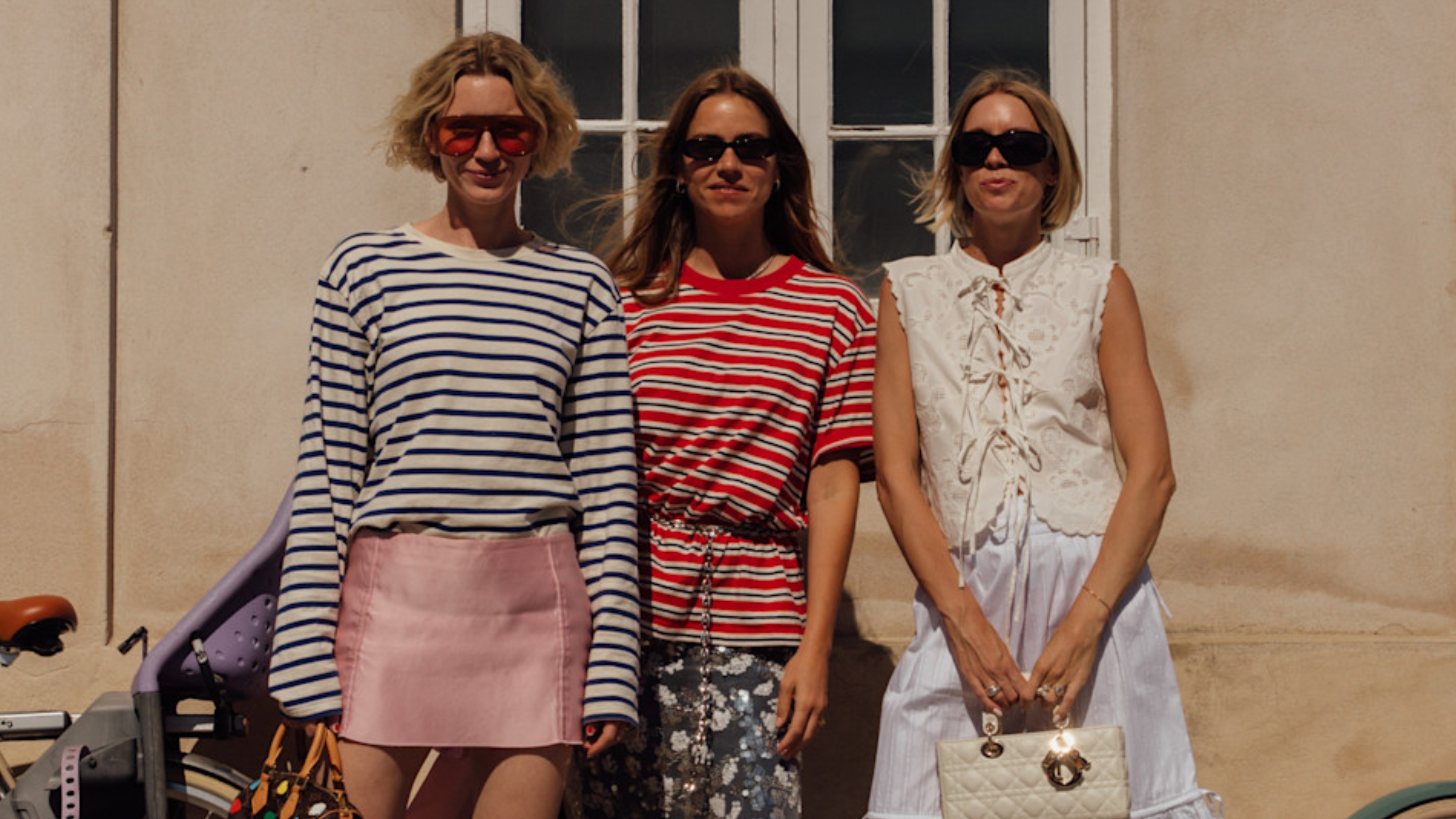 woman wearing a striped shirt and a pink skirt, woman wearing a striped shirt and a floral skirt, woman wearing a white top and a white skirt,