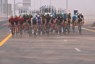 The peloton gets a face full of sand
