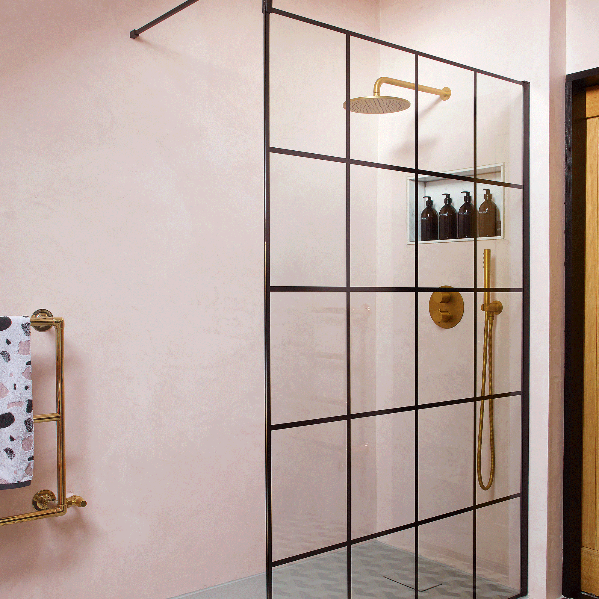 Pink tiled bathroom with crittal shower screen