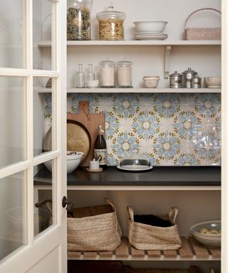 A pantry decorated with blue and white Italian style tiles