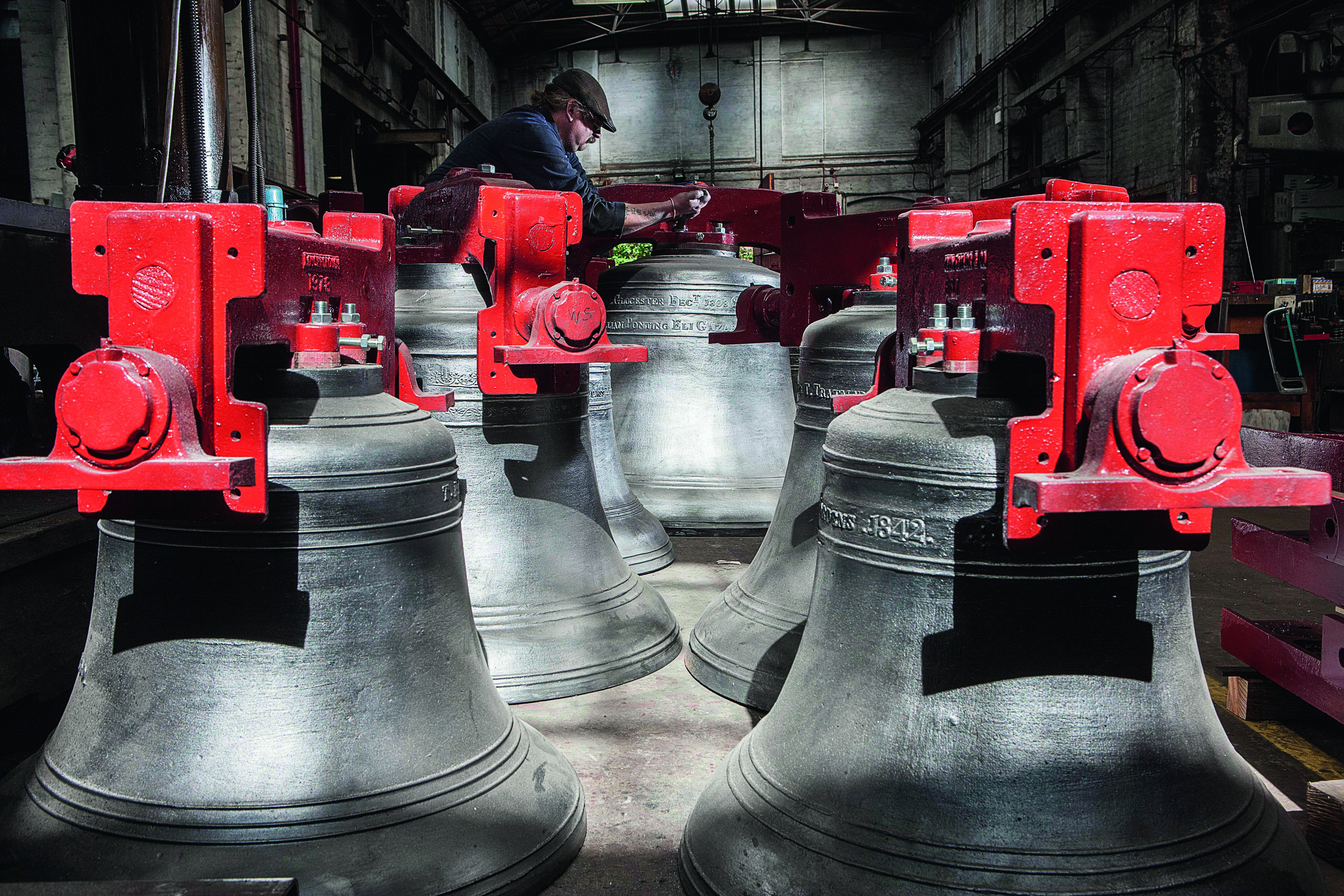 A worker at John Taylor &amp;amp; Co works on engraving a gigantic bell