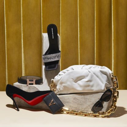 Various luxury goods for resale on display, including high heels, a purse and sunglasses from brands like Christian Louboutin and Valentino.