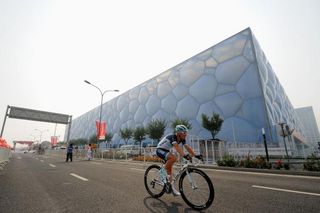 A Leopard Trek rider goes by the Cube in Beijing during the opening stage time trial