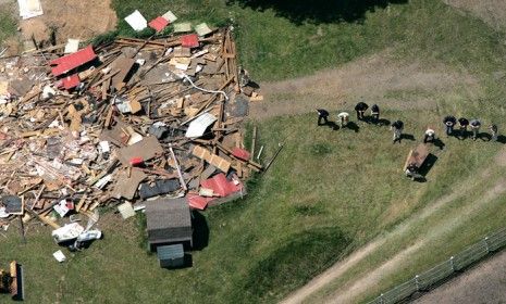 An FBI-led crew probes the ground in search of Jimmy Hoffa&amp;#039;s body near a demolished barn on a horse farm in Milford Township, Mich., on May 24, 2006.