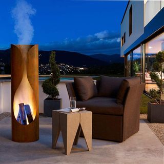 Modern corten steel outdoor fireplace on a patio