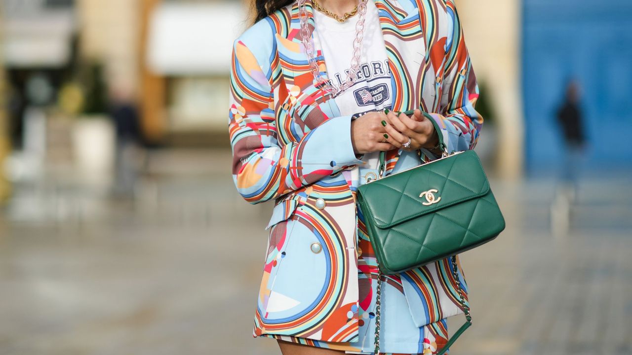 Woman wearing olive nails and an olive Chanel flap bag