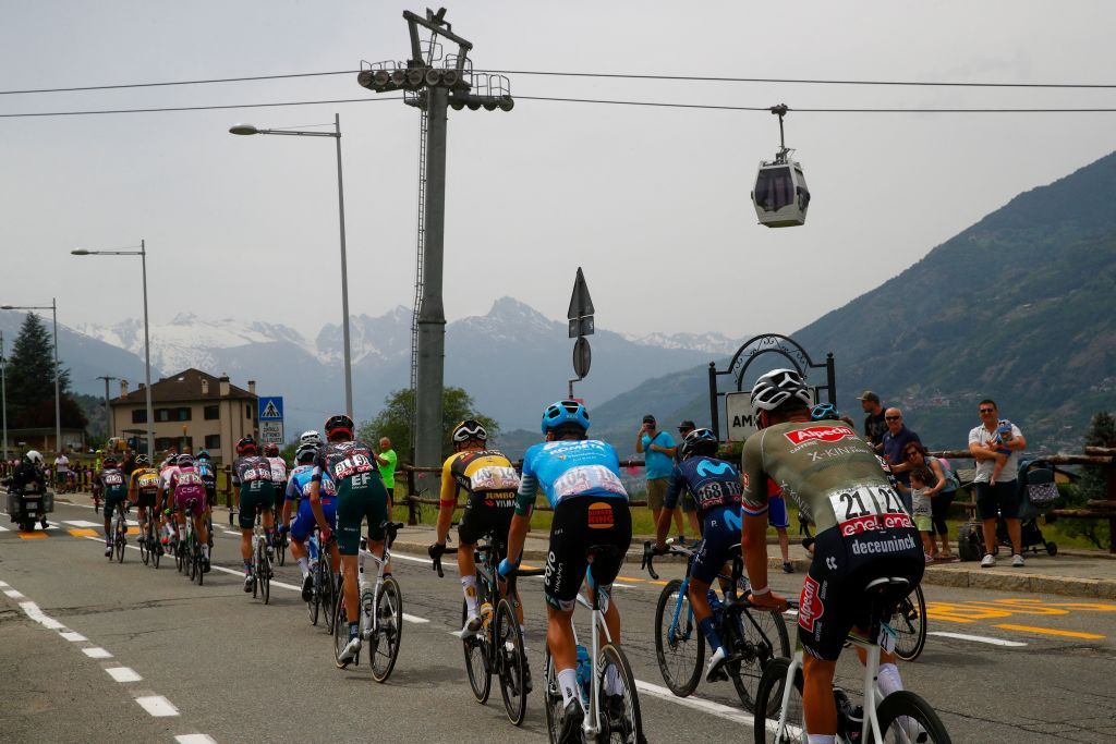 Spectators cheers as the pack of riders cycles past during the 15th stage of the Giro dItalia 2022 cycling race 177 kilometers from Rivarolo Canavese Piedmont to Cogne Aosta Valley on May 22 2022 Photo by Luca Bettini AFP Photo by LUCA BETTINIAFP via Getty Images