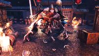 A grotesque skeletal creature looms in a firelit ship’s hold, surrounded by barrels, crates, and debris in a tense fantasy battle scene.