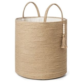 A tall woven storage basket with woven handles. 