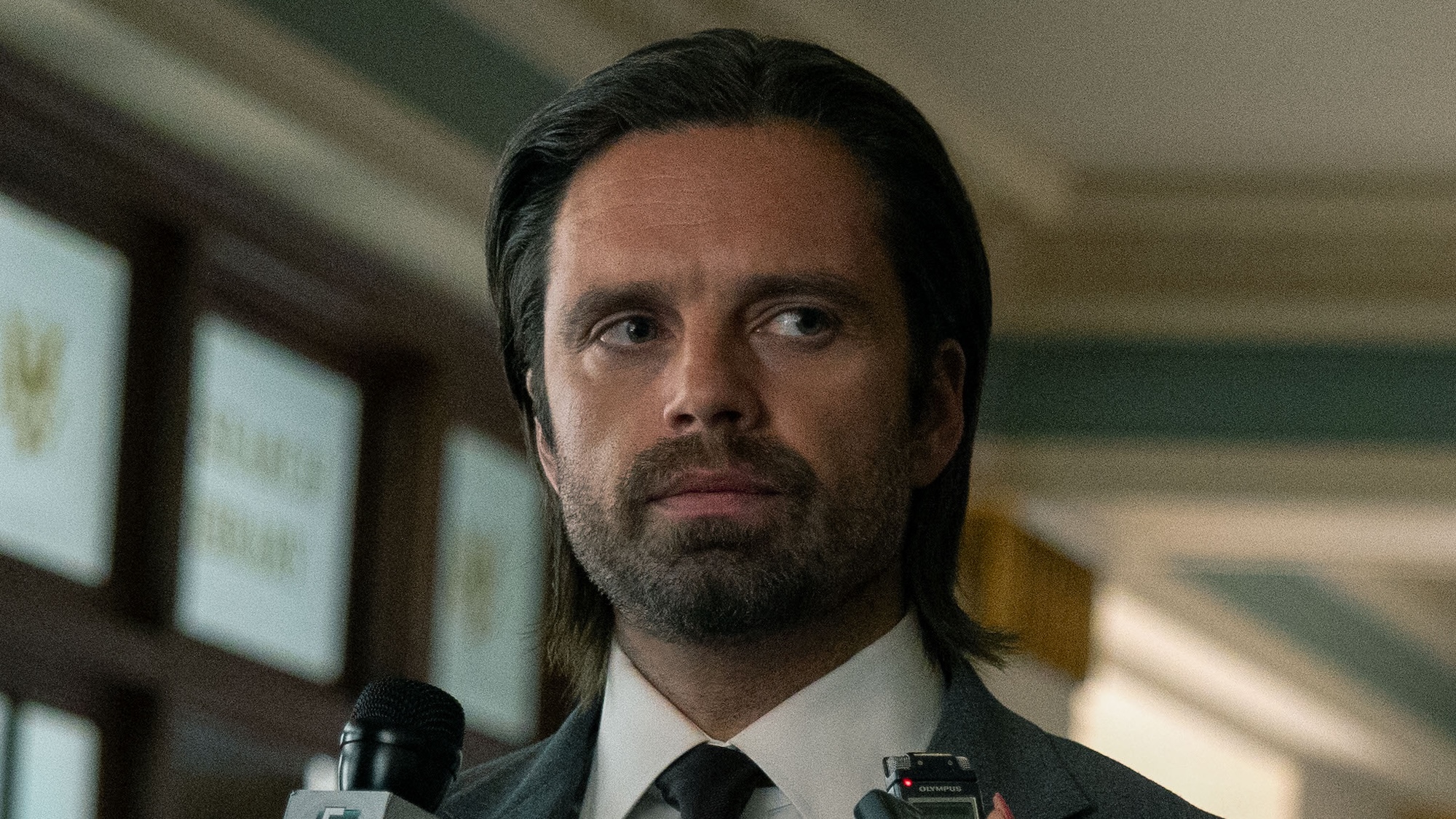 Bucky in a suit being interviewed by news journalists in Thunderbolts*