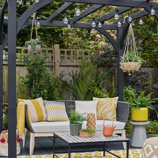outdoor garden with cushion and hanging potted plants
