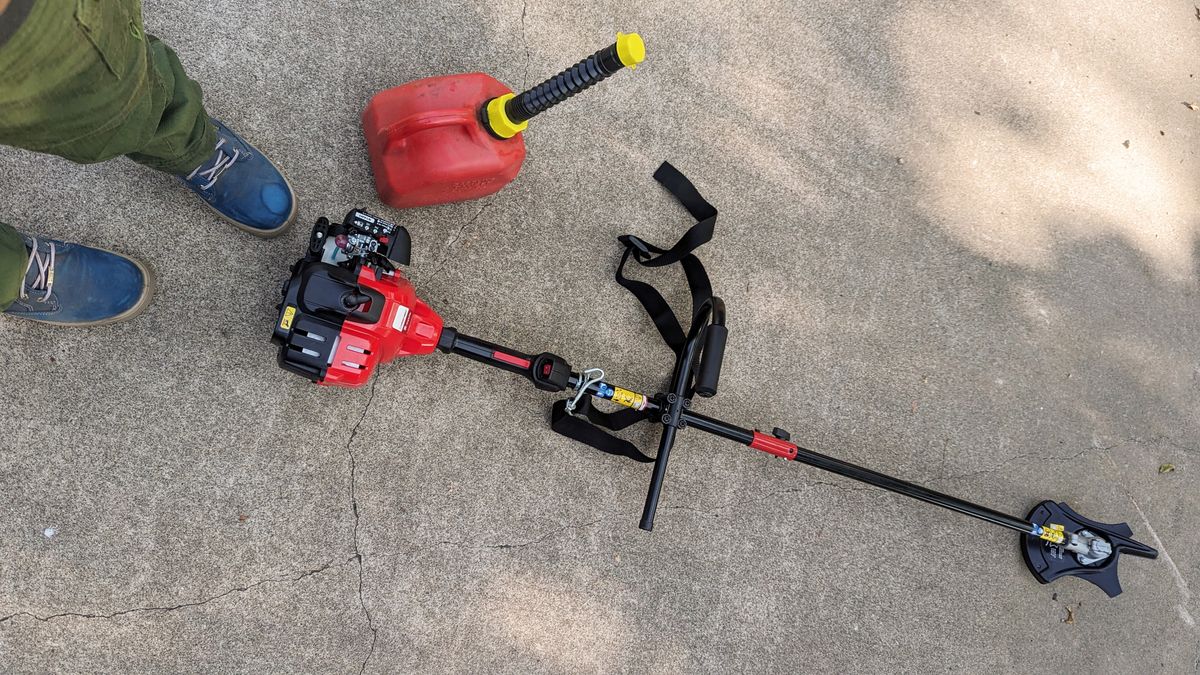 Troy-Bilt TB272BC XP Straight Shaft Brushcutter on ground beside tester&#039;s feet