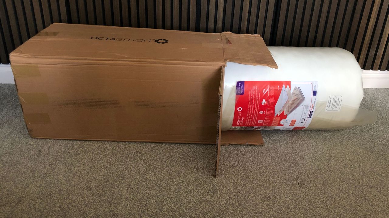 The Octasmart Deluxe Topper being pulled out of shipping box