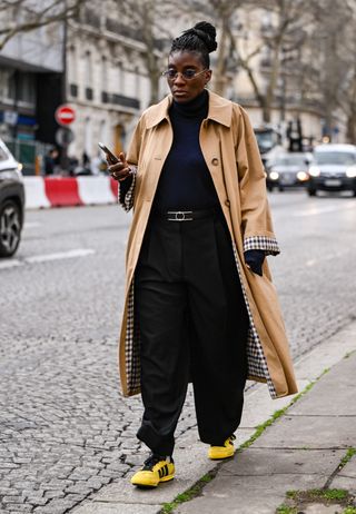 Nikki Ogunnaike wears the sezane clyde trench coat at Paris Fashion Week