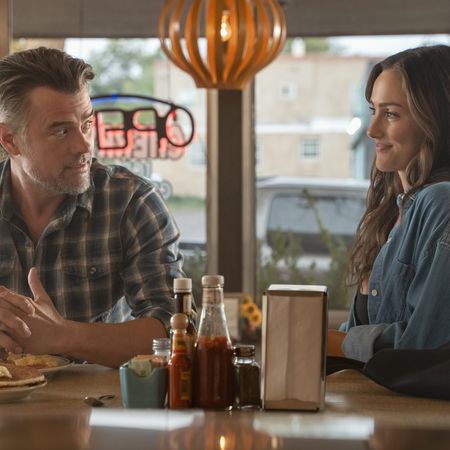 Josh Duhamel as Staten and Minka Kelly as Quinn look at each other while sitting at a diner counter in Episode 203 of 'Ransom Canyon' Season 2.