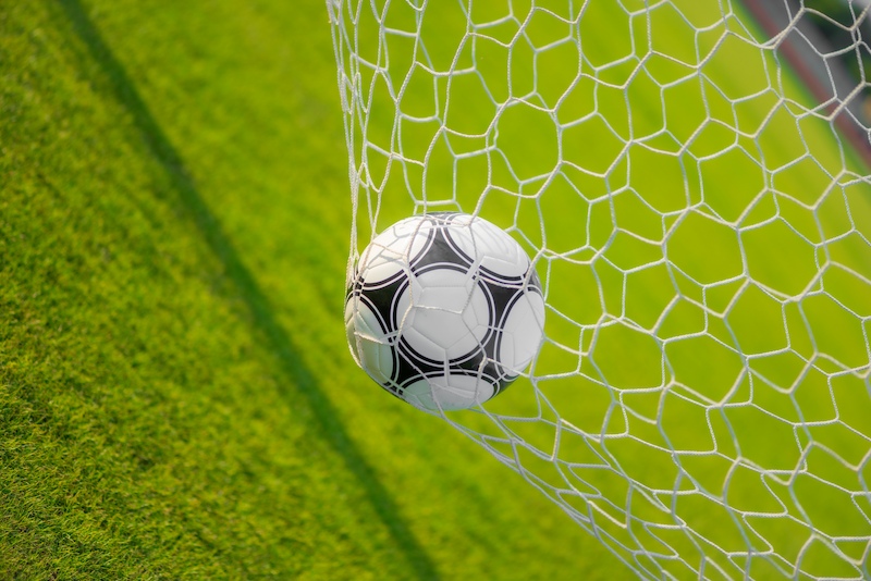 A football in a football goal.