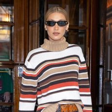 Bella Hadid wearing a striped sweater in London