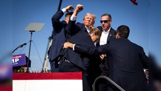 Donald Trump being pulled away by security guards after assassination attempt 