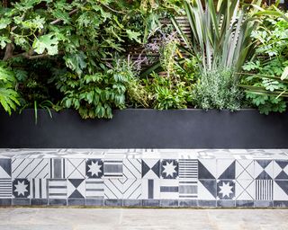 outdoor bench tiled in patterned black and white tiles