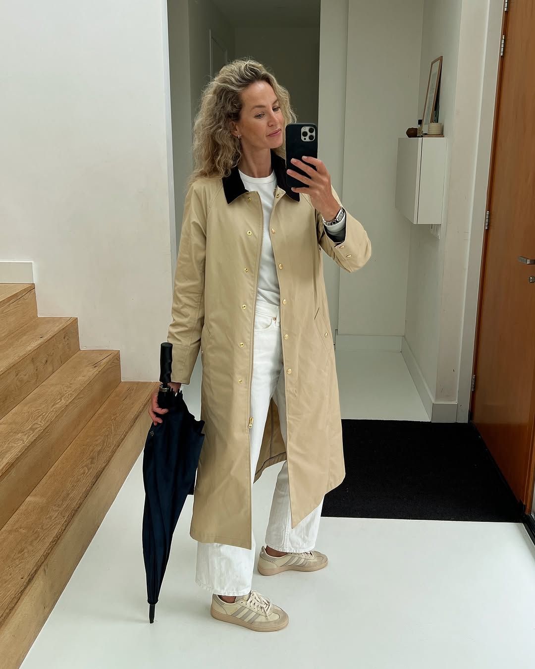 @anoukyve wearing a barn jacket and white jeans