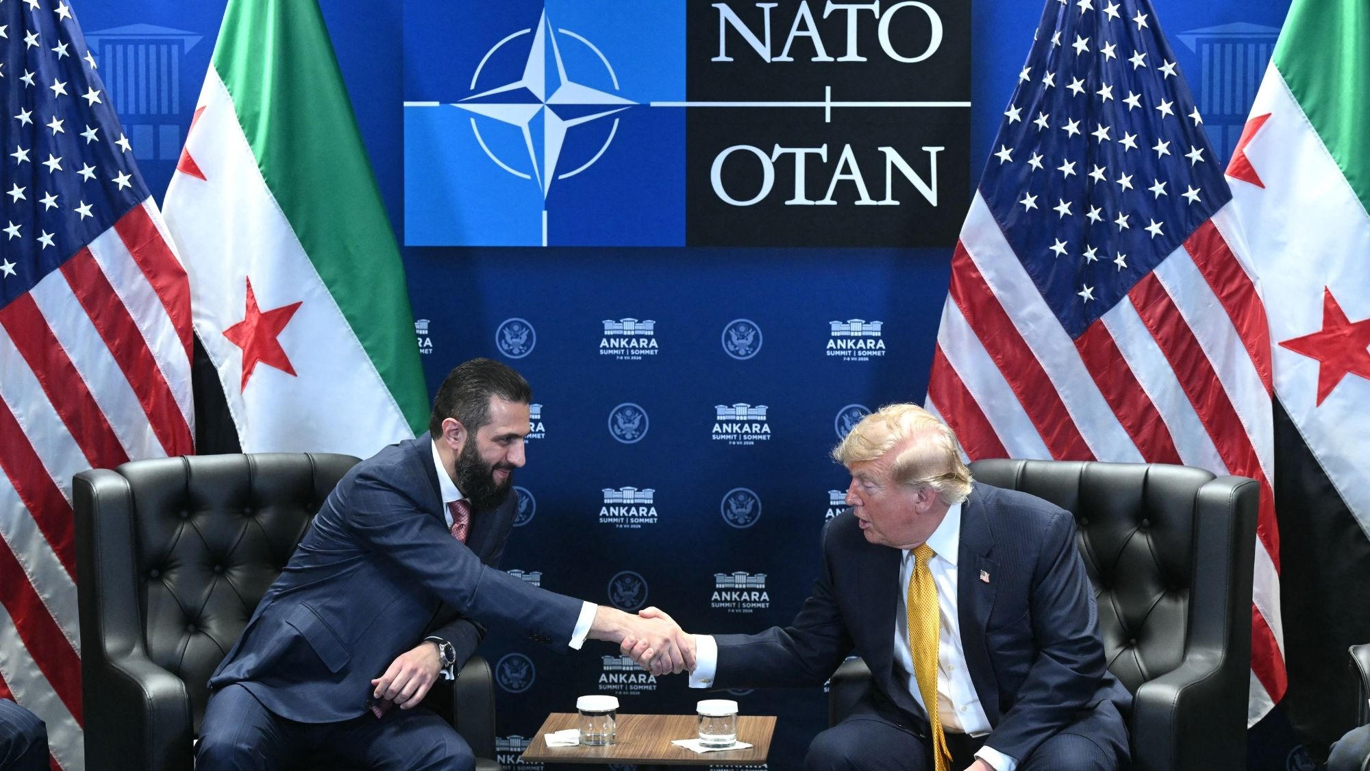 US President Donald Trump (R) meets Syrian President Ahmed al-Sharaa (L) 