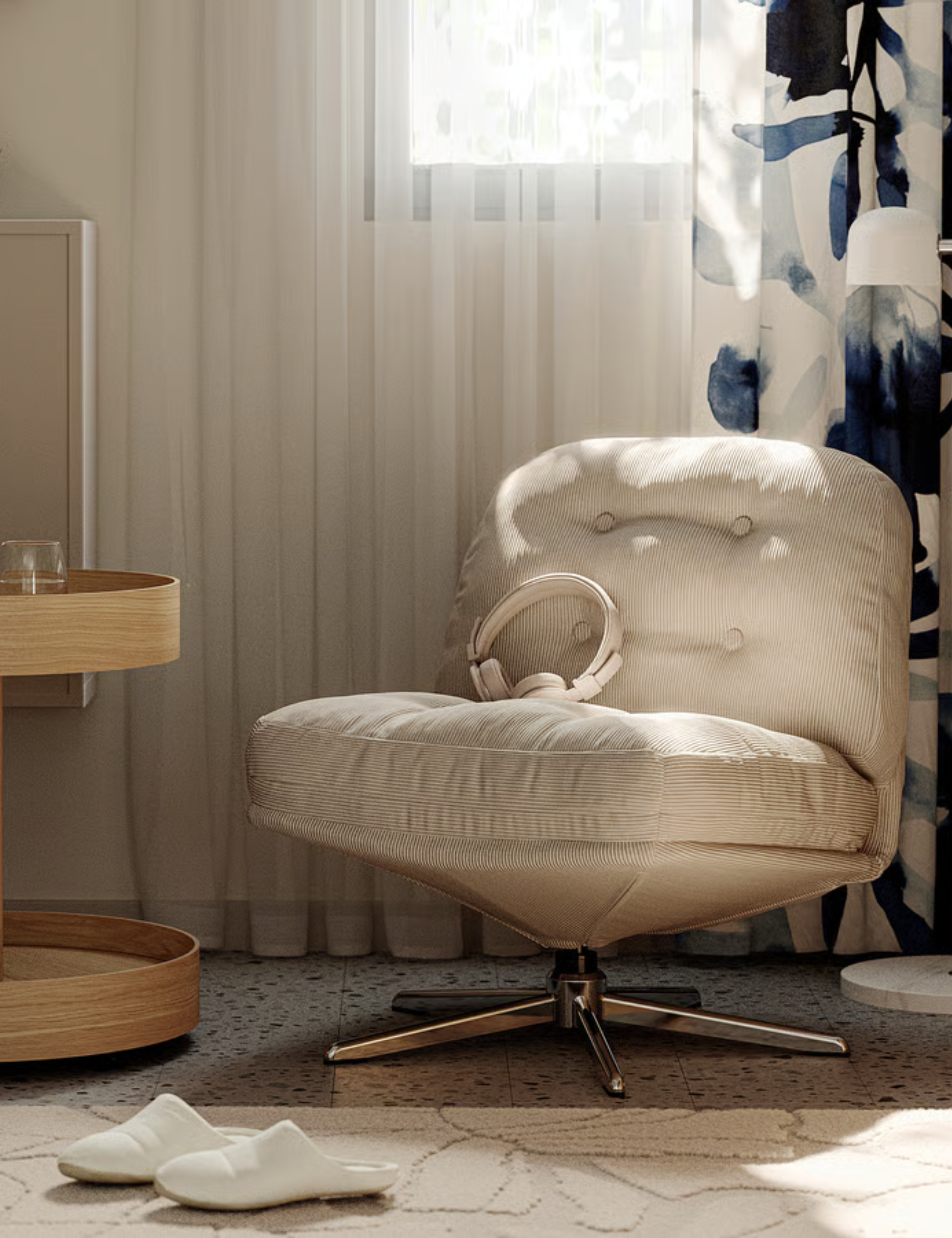 Neutral living room featuring a low slung beige tufted swivel chair, accented by light wood furniture