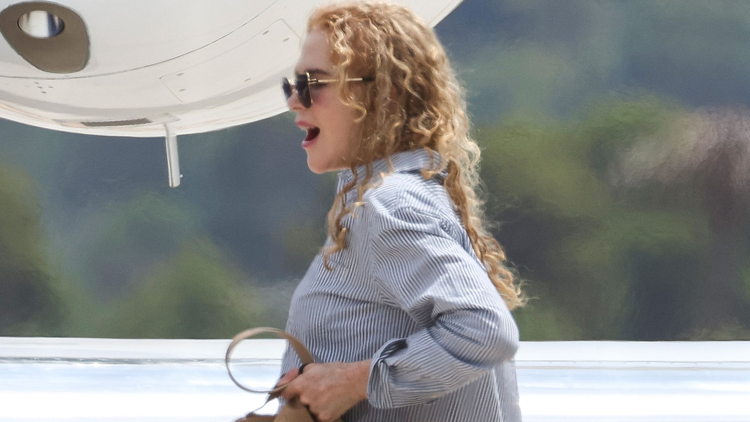 The Row Bag Celebs in Their 50s Pair With Cuffed Jeans and White Sneakers at the Airport