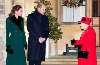 Catherine, Duchess of Cambridge, Prince William, Duke of Cambridge and Queen Elizabeth II wait to thank local volunteers and key workers for the work they are doing during the coronavirus pandemic and over Christmas in the quadrangle of Windsor Castle on December 8, 2020 in Windsor, England