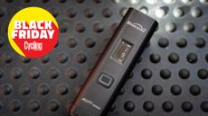 Magicshine Allty1500s front bike light laid on a bench with the Cycling Weekly Black Friday roundel in the top left