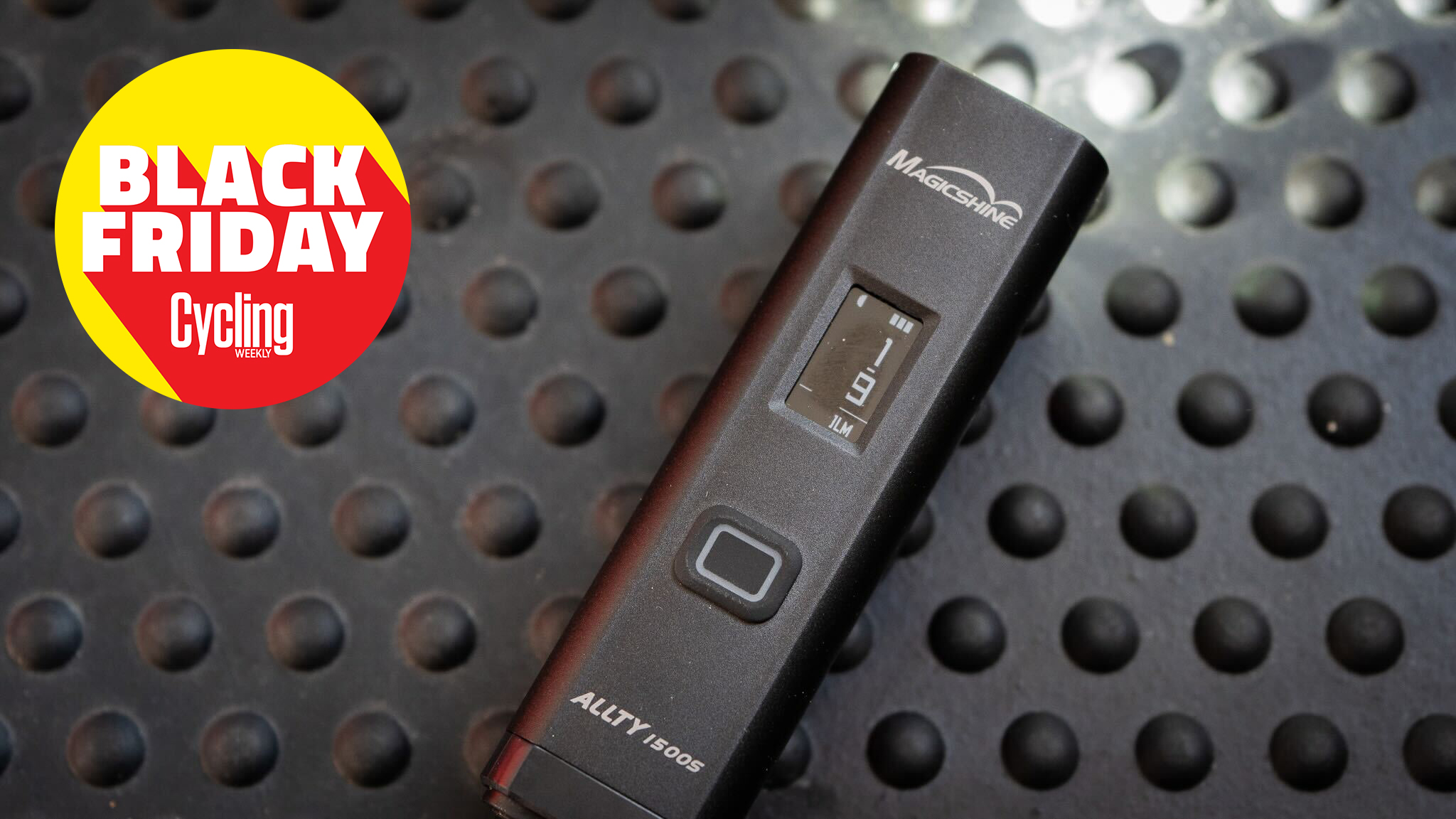 Magicshine Allty1500s front bike light laid on a bench with the Cycling Weekly Black Friday roundel in the top left