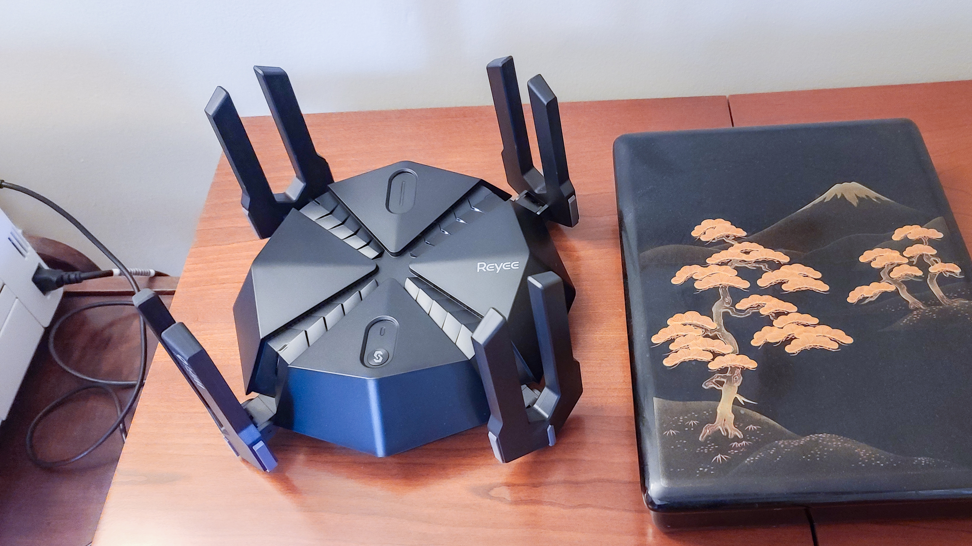 Reyee RG-E6 gaming router on a coffee table