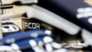 The Epicor logo seen on the side of a blurred out Formula 1 car