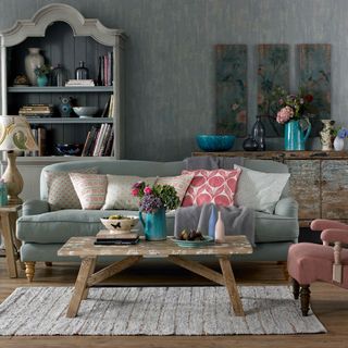 brushstroke design on wall with sofa and cushions with wooden table