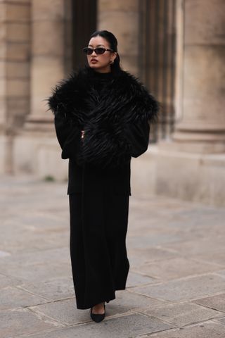 womand wearing faux fur coat and heels