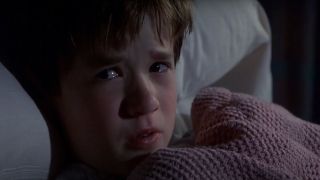 Haley Joel Osment crying while hiding in his blankets in The Sixth Sense.