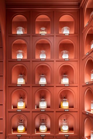 Romanengo Milan sweet shop with jars on terracotta-coloured lit shelves