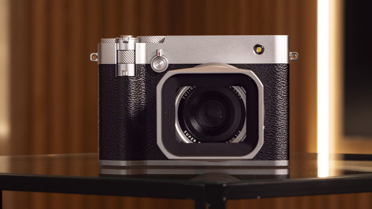 Fujifilm GFX100 RF medium-format compact camera on a glass table, front