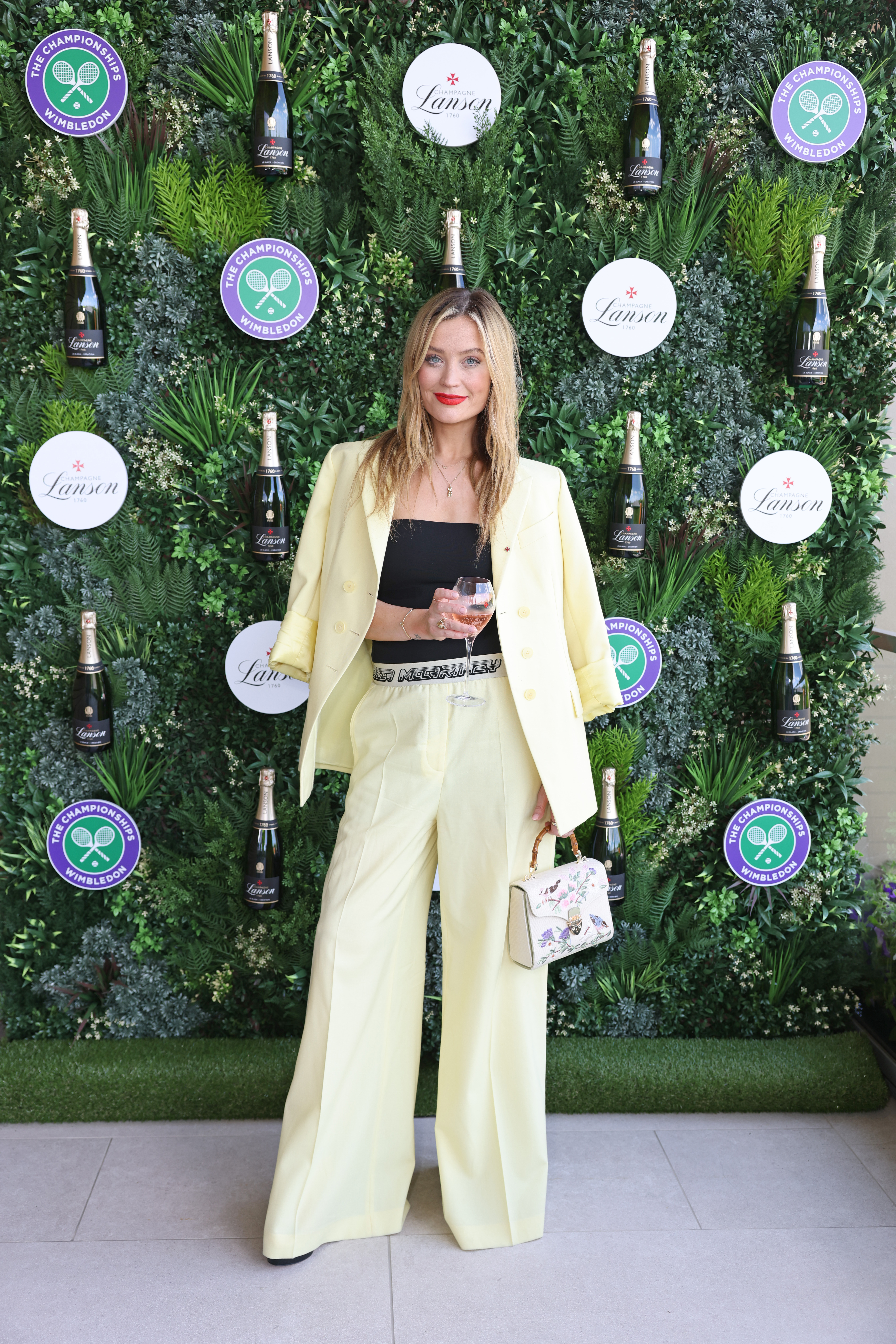 Laura Whitmore comes in a butter yellow suit set for Wimbledon day.