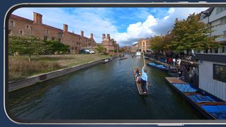 A 360 camera image of an oarsman on the back of a river boat on a smartphone screen
