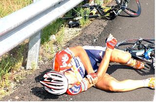 Josep Jufre (Davitamon-Lotto) stems the blood flow after cutting his arm open on a roadside barrier