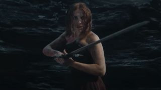 A screenshot of Millie Bobby Brown holding up a sword in Damsel.